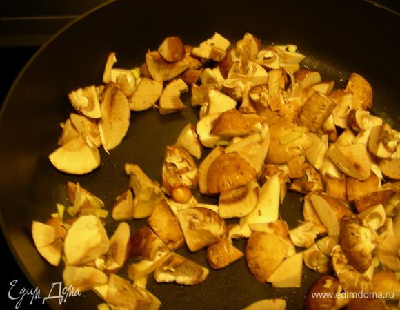 Пасту отвариваем до готовности, оставляем немного воды от ее приготовления. Грибы нарезаем пластинами и обжариваем с измельченным чесноком на смеси масел минут 5. 

