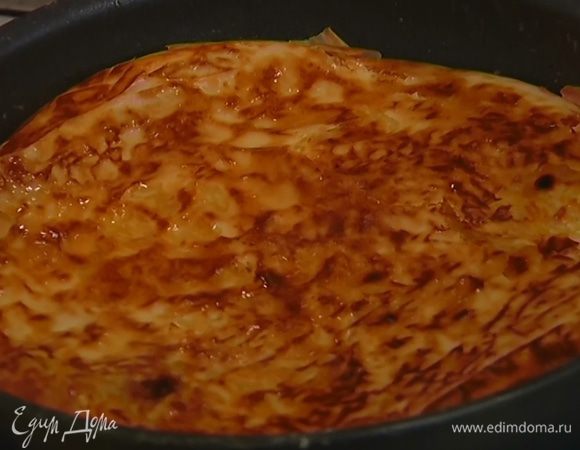 Поместить сковороду с пловом на огонь, накрыть крышкой и обжаривать минут пять. Затем перевернуть тесто с пловом и обжаривать с другой стороны до появления поджаристой корочки.