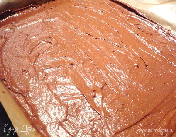 Готовим наш шоколадный бисквит. Просеиваем муку, смешанную с какао, просеиваем. Масло взбиваем до кремообразного состояния, добавляем пудру из тростникового сахара, продолжая взбивать, вводим белки, добавляем муку и какао, взбиваем до однородности. Выкладываем на застеленный пекарской бумагой противень.