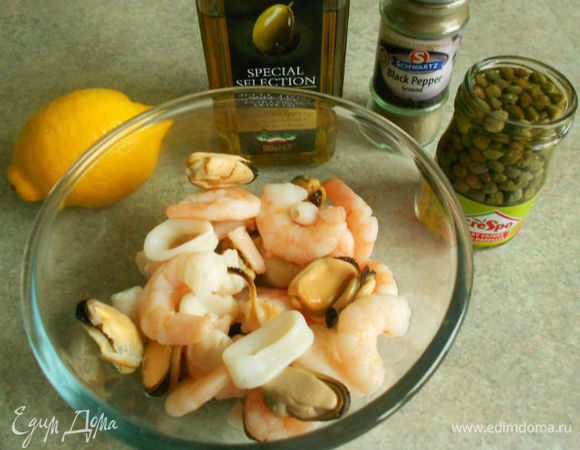 Морепродукты разморозить, смешать с перцами, каперсами и петрушкой. Взбить вилкой в миске все компоненты заправки и полить салат.