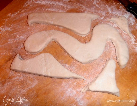 Сначала размораживаем тесто и вырезаем произвольную основу-змейку.Раскатывать НЕ надо, должно подняться типа "язычков". Моё тесто толщиной 1 см, ушло оба пласта (из обрезков печём печенье).