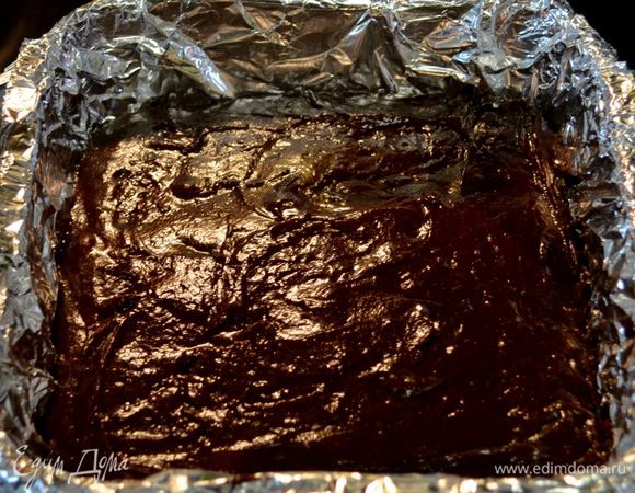 Выложить все в приготовленную форму, распределить тесто лопаткой.
Выпекать в разогретой духовке 35 мин. Проверяем центр зубочисткой.
Готовый брауни достать из духовки и дать остыть 10 мин. Затем с фольгой достанем из формы брауни и дадим полностью остыть на решетке.
Разрежем по горизонтали на 2 части (по рецепту), у меня на 3 вышло, брауни хорошо поднялся.
Используем квадратную вновь форму, выложим ее пищевой пленкой по форме. Положим нижнюю часть брауни. Отставим в сторону.