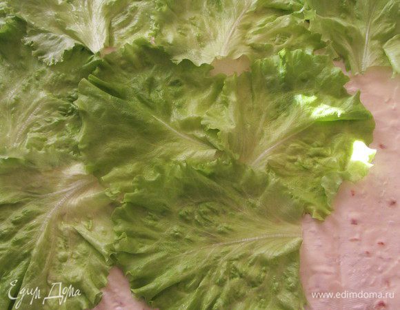 Лаваш разрезать пополам.
Одну половину  смазать сыром (я обычно беру сливочный без добавок). Сверху выложить листья салата.