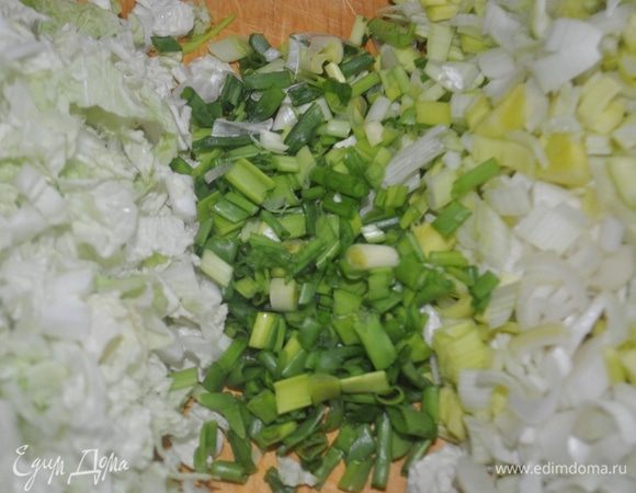 Китайскую капусту, лук-порей, зелёный лук, зубчики чеснока мелко нарезать.
