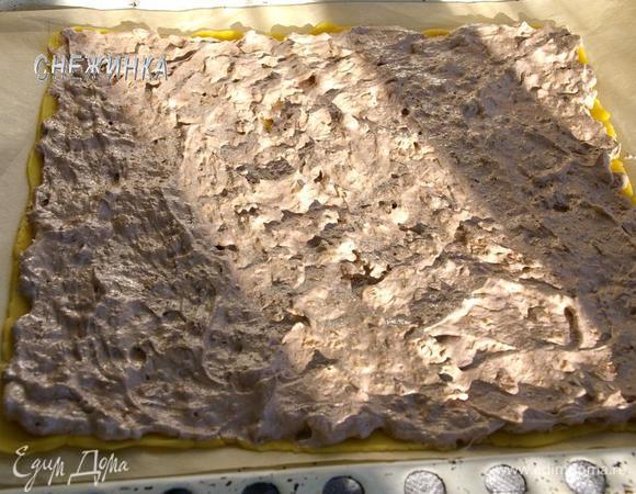 Переносим пергамент с тестом на противень. Распределяем равномерно начинку по всей поверхности.