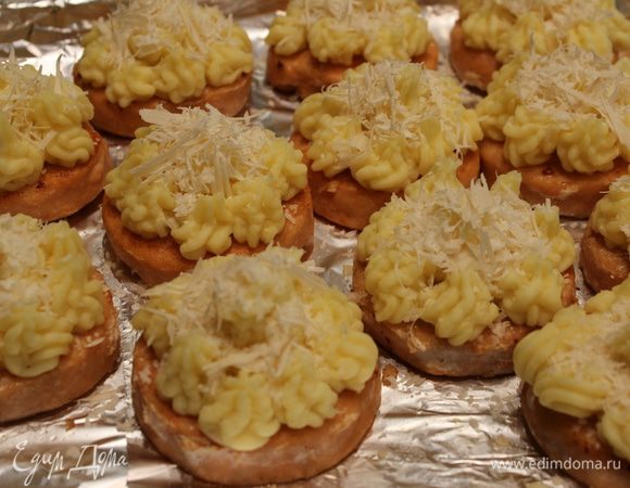 Выложить медальоны на противень, застеленный фольгой. Сверху выложить картофельное пюре (можно при помощи кондитерского мешочка), присыпать натертым Пармезаном и запекать в предварительно разогретом духовом шкафу минут 20 при температуре 200 градусов