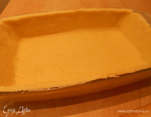 Огнеупорную форму смазать жиром (слив/раст. масло, маргарин, кулинарн.жир); тесто раскатать скалкой  или распределить руками уже в форме; наколоть вилкой, отправить в холодильник