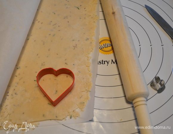 Достанем из холодильника один кусок. Дадим постоять при комнатной тем-ре 5 мин. Раскатаем тесто не тонко  на бумаге между двумя листами для выпечки.
Вырежем из теста фигуры.