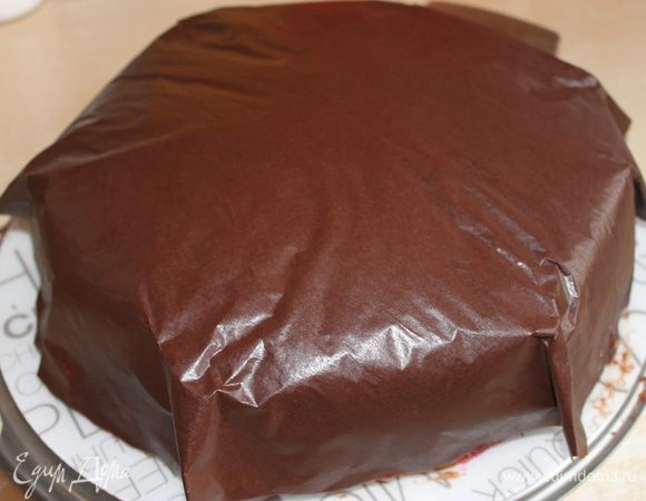 Когда шоколад начнет застывать но еще не совсем, достаем торт с холодильника, берем аккуратно покрывало и накладываем на торт.Тут главное попасть в центр, не промазать... Слегка прижимаем... углы не надо делать острыми как у меня на фото... пусть они свисают свободно. Ставим его в холодильник на час примерно..