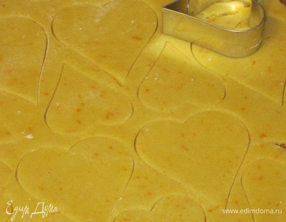 На рабочей поверхности присыпанной мукой раскатать тесто и вырезать формой сердечки.