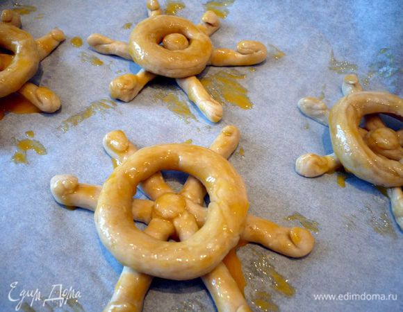 Для украшения замешиваем тесто из муки, смешанной с разрыхлителем и солью, и масла с творогом, лепим вот такие штурвалы. Смазываем их желтком. Духовку разогреваем на 180 градусов.