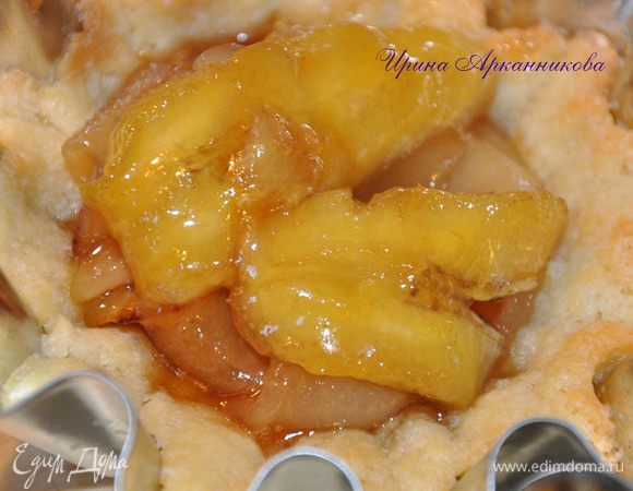 Замесить в комбайне тесто(чтоб скаталось в мягкий шар) ,выложить в формочки, смазанные маслом (силиконовые не надо смазывать). Поставить на 30 минут в хол-к. Испечь при темп-ре 180 с около 15 - 20 минут до почти полной готовности.

Карамелизация фруктов: на сковороде растопить 100 г слив.масла,100 г сахара, 2 ст. л. рома, 2 ст. л. воды. Как только смесь начнет темнеть (через 10 - 15 минут на огне ниже среднего), выложить дольки груши без кожуры, если они твердые, а позже бананы. Если мягкие груши, то выкладывать сразу и бананы.  Обжарить до румяного цвета. Остудить. Выложить в корзинки фрукты. Сверху выложить меренгу (1 белок взбить с щепоткой соли, потом добавить сахар, около 50 г). Посыпать орехами. Выпекать при 180 с около 15 минут 