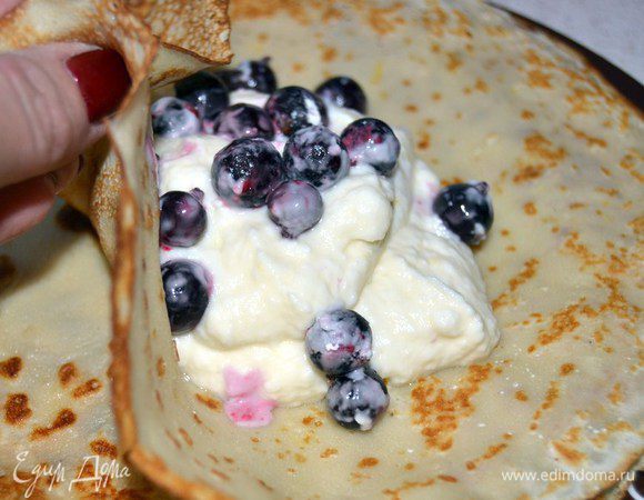 Выкладываем на готовый блин творожную начинку и немного ягод.Собираем в мешочек.