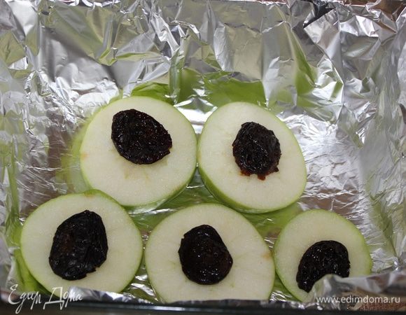 У яблок вырезать сердцевину и нарезать кольцами толщиной около 1см, чернослив  промыть. Фольгу положить в форму для запекания.
На  фольгу  выложить  яблоки, сверху чернослив.
