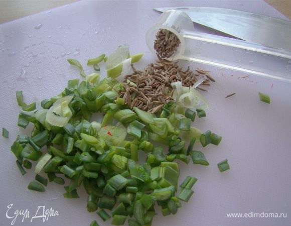 Мелко рубим лук, добавляем с тмином в кастрюлю, перемешиваем