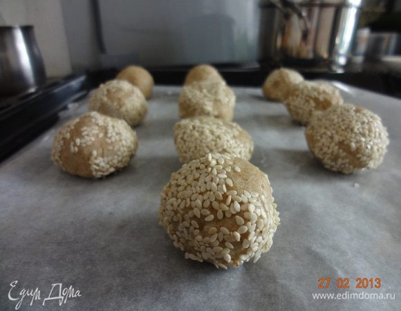 Хотела уже отправить в духовку, но в последний момент решила обвалять в кунжуте. Так вот в тарелочку насыпаем горсти две кунжута и обваливаем колобочки. Теперь на противень и в духовку минут на 45-50. Следить, чтобы кунжут не подгорал и сами колобки сильно не румянились.