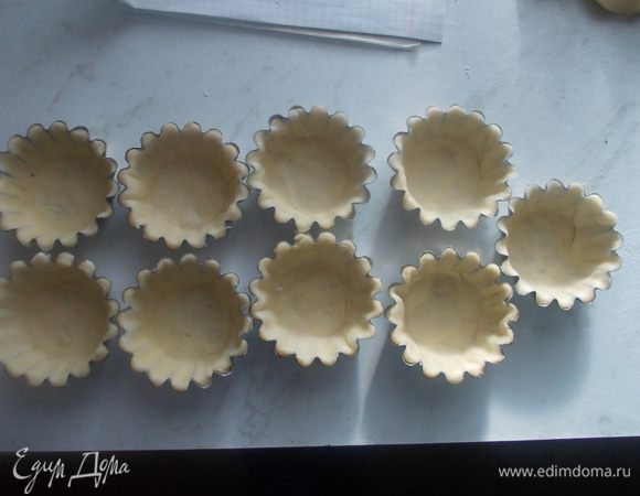 Раскатать тесто и выложить его в формочки смазанные маслом. Прижать по краям, чтобы тесто прилегало к  форме.