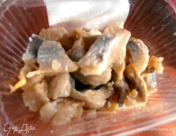 Сельдь проверить на лишние косточки и нарезать на мелкие части.