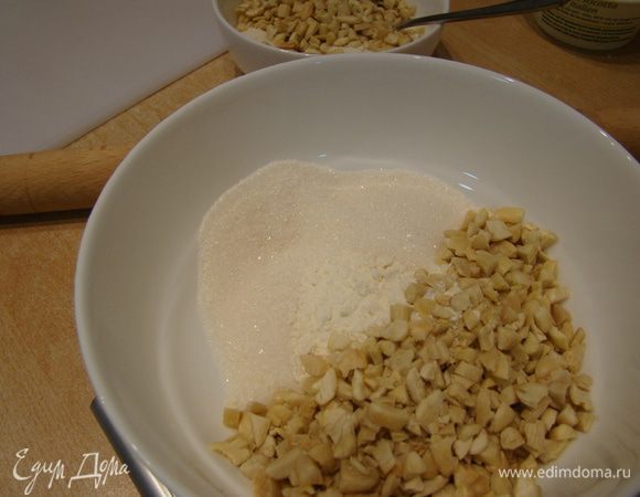 В двух мисках смешать по половине нормы муки, сахара, орехов