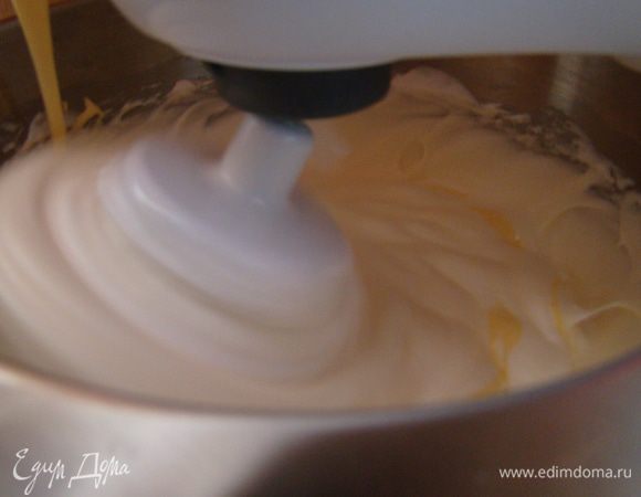 Не выключая миксер, ввести желтки в безе
