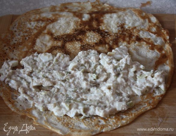 Берем блинчик. Наносим тонким слоем начинку на половину блина и начинаем сворачивать рулетиком.