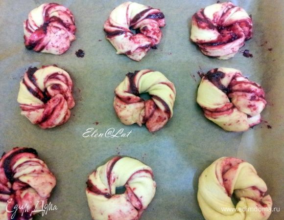 Каждую полоску перекрутить жгутом 3-4 раза и свернуть колечком, концы защипнуть. Выложить на противень на пекарскую бумагу