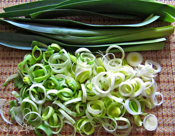 Лук порей промыть. Белую часть нарезать тонкими кольцами. Зелёную часть отложить.