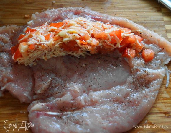 На край филе положить начинку и аккуратно ее прижать.