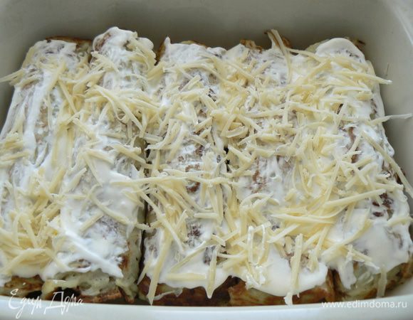 Смазать рулетики сметаной, посыпать натертым сыром и порезанной зеленью.