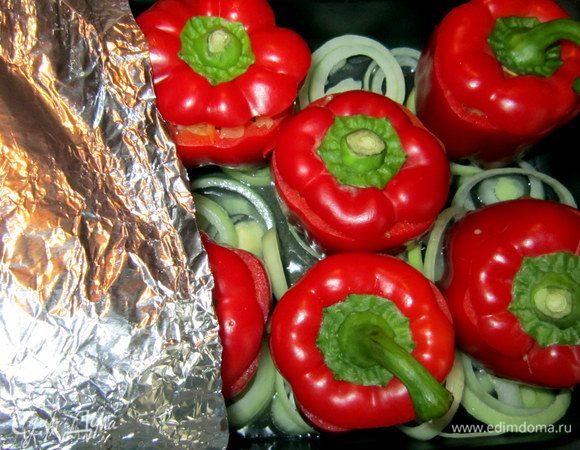 Перчики закрыть крышечками. Противень накрыть фольгой и поставить в разогретую до 200 г духовку на 40 мин.
