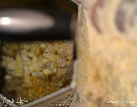 Холодное сливочное масло натереть на терке, захватывая муку.