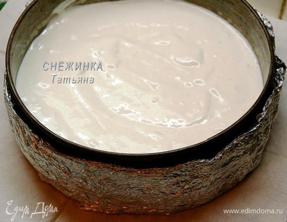 Отдельно просеиваем муку с разрыхлителем и аккуратно постепенно вводим в тесто. На дно разъёмной формы для выпечки кладём пергамент, смазанный маслом. Снаружи форму я обернула мокрым полотенцем, смоченным в воде и завёрнутым в фольгу для лучшего выпекания бисквита. Тесто равномерно выкладываем в форму.