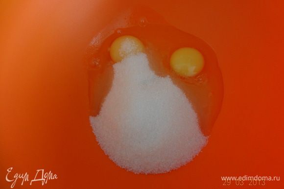 В глубокой миске смешать яйца и сахар, взбить венчиком.