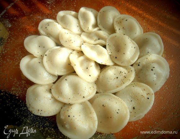 Выкладываем слой из половины пельмешек.Если их осталось мало от обеда-ничего страшного...,выкладывайте все вниз для пропитки грибными соками.Немного припорошим перчиком, т.к. при варке пельмени теряют много вкусовых приправ.