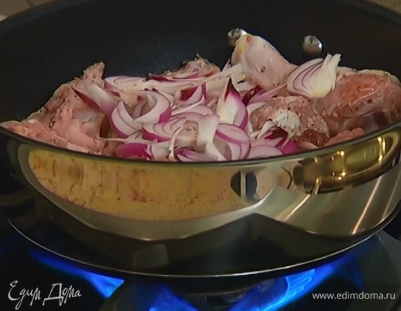 Луковицу почистить, нарезать дольками и добавить в сковороду, перевернуть окорочка и обжаривать лук и курицу до золотистого цвета.