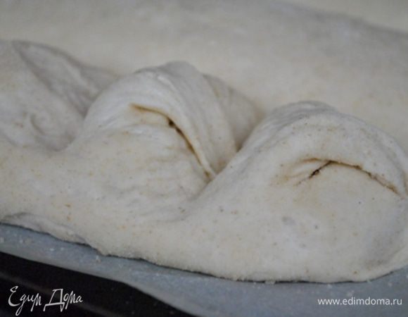 Взять верхний острый уголок теста и как бы повернуть тесто в обратную сторону и придавить, на фото видно, как это сделать: