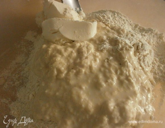 Смешать сухие дрожжи с 100 г муки. Влить 50 мл тёплой воды. Хорошо размешать. Накрыть ёмкость плёнкой и оставить, пока дрожжи активизируются. Займёт 30-40 минут.

Смешать подошедшие дрожжи с оставшейся мукой, добавить 50 мл тёплой воды. Добавить сыр, сахар. Размешивать ложкой, начиная с центра, постепенно подмешивать муку.