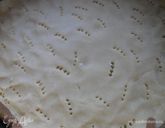 Вынуть тесто из холодильника, большую часть раскатать, сделать бортики  и поместить в форму  ( 26 см) на лист бумаги для выпечки. Проколоть тесто в нескольких местах.

