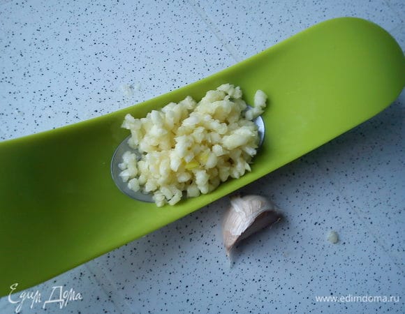 Чеснок выдавить на крупную чеснокодавку или мелко порезать