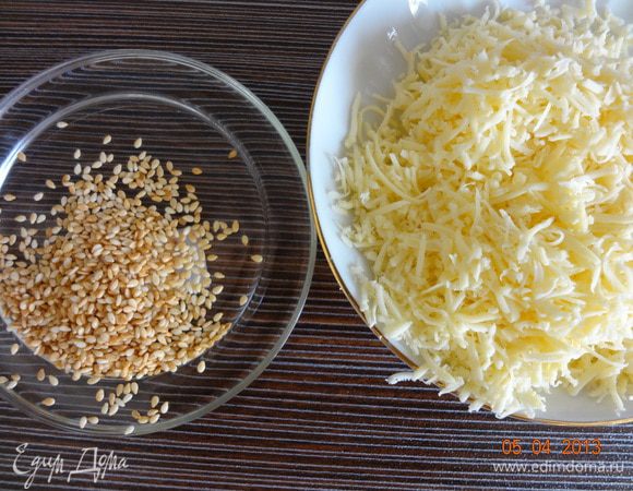 Семена кунжута подсушить до золотистого цвета на сухой сковороде, сыр натереть на мелкой терке.