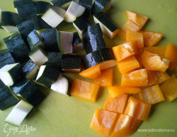 Нарезать цукини вдоль на четыре части, а затем на кусочки толшиной 2 см, а сладкий перец квадратами такого-же размера

