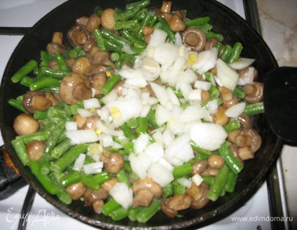 Высыпаем в грибы стручковую фасоль и перемешиваем, добавляем порезанный репчатый лук, опять перемешиваем.