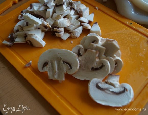 Шампиньоны споласкиваем, зачищаем немного от темной шкурки и нарезаем сначала пластинами, затем еще на несколько частей.