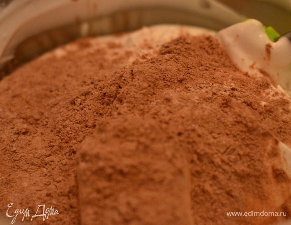 Теперь постепенно ко взбитым белкам добавляем просеянную муку с какао-порошком, и аккуратно,но оперативно перемешиваем лопаткой в одном направлении снизу вверх.