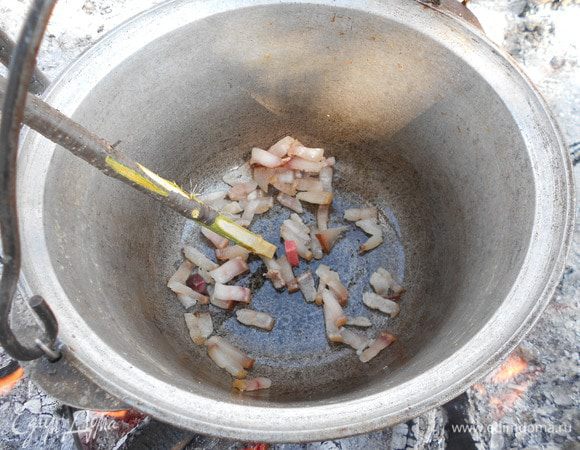 Над костром подвешиваем котелок и последовательно обжариваем сало...