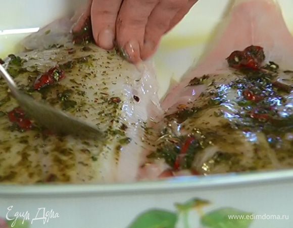 Керамическую форму для выпечки смазать оливковым маслом, выложить рыбу, обмазать со всех сторон пряной заправкой и дать постоять 10 минут.