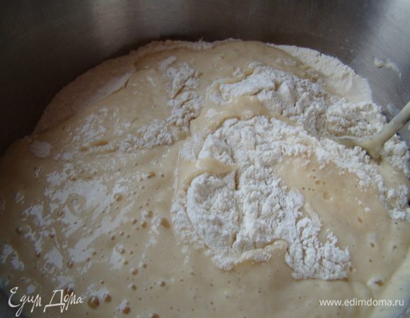 Просеем муку, выльем в нее опару, начнем замешивать тесто