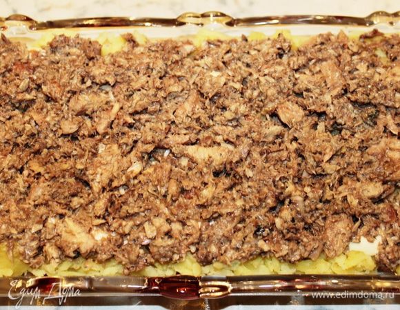 Второй слой - лук, мелко порезанный, и сайра, измельченная вилкой