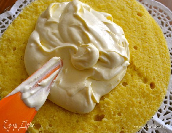 Затем выложить на бисквит оставшийся крем, оставив совсем немного для смазывания боков торта. 