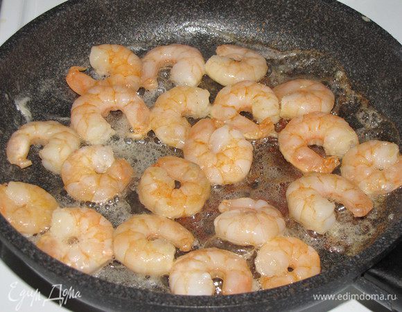 Приготовим соус. Разогреть растительное масло в сковороде и обжаривать креветки на сильном огне в течении 2-3 минут.